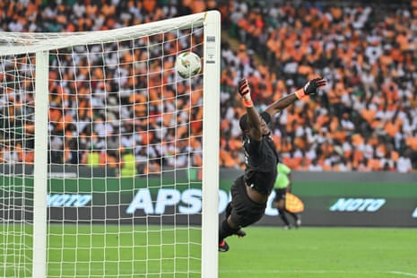 Ivory Coast's goalkeeper Yahia Fofana concedes a goal to Equatorial Guinea's Pablo Ganet from a free kick.