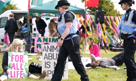 Police liaison officers at an animal rights protest group organised by Animal Rising outside the entrance of the racecourse.