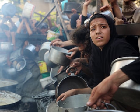 A charity distributes meals to Palestinians facing food shortages amid ongoing Israeli attacks