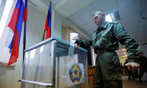 Service members in occupied Luhansk vote in a referendum that Ukraine has condemned as propaganda.
