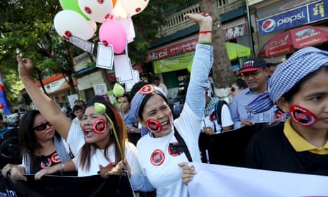 Women hold a banner as they shout during a protest against the new law to regulate non-governmental organisations in Phnom Penh, Cambodia, in July.<br>