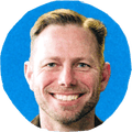 man smiling against blue background