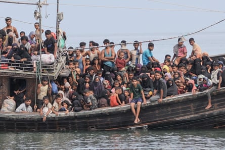a crowded boat full of refugees waits at sea for permission to go on land