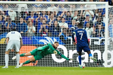 Italy's keeper Gianluigi Donnarumma denies France's Ousmane Dembele (right).