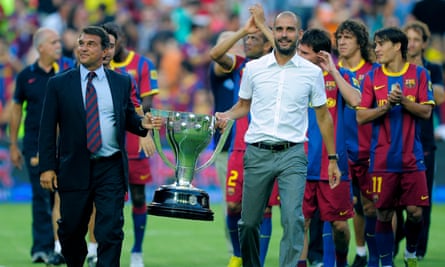Joan Laporta (left) shows off the La Liga trophy with Pep Guardiola and Barcelona players in 2010.
