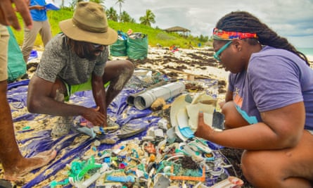 Kristal Ambrose examines plastic washed up on the beach