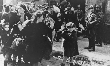 A group of Jewish Poles surrender to German soldiers after the collapse of resistance in the Warsaw Ghetto In in April 1943.