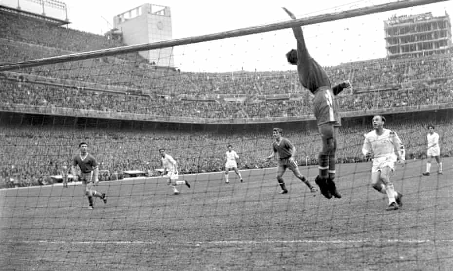 Manchester United goalkeeper Ray Wood throws the ball over the crossbar, watched by Real Madrid's Alfredo Di Stefano, during the second leg of the 1957 European Cup semi-final.