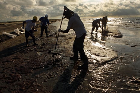 Workers hired by BP rake up globs of oil that washed ashore and coated the beaches in 2010 near Port Fourchon and Grand Isle in Southern Louisiana. Each wave brought a new batch of oil for workers to clean.