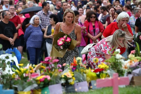 Mourners lay flowers during a vigil to remember murdered Queensland woman Hannah Clarke and her three children in February 2020