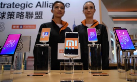 Mobile phones are displayed at a joint press conference by Xiaomi and Hutchison to announce the partnership with Three.