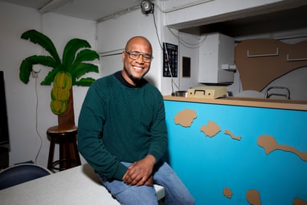 Portrait of Alexander Soares Silva sitting in the basement of the São Nicolau cultural centre in Rotterdam