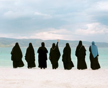 Rhianna Adam, Three generations, Lake SaldaThree generations of Muslim women on the banks of Lake Salda, aka the “Turkish Maldives”; which is also Earth’s closest match to the geology and mineralogy of the Jezero Crater on Mars. To avoid Haram, the women’s backs are turned away from the camera.