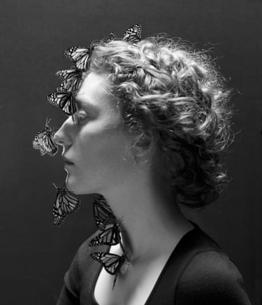 Woman with butterflies on her face, a photograph by Juul Kraijer