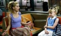 Brittany Murphy and Dakota Fanning sitting on a subway train