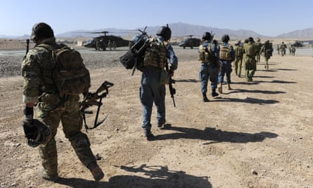 Afghan officers and Australian soldiers walk towards a Black Hawk helicopter in Kandahar