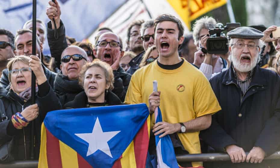 Pro-independence activists demonstrate at the Catalan parliament as Carles Puigdemont, mayor of Girona, was chosen as regional president. 