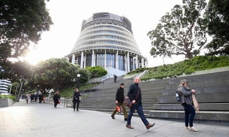 Pedestrians walk past the Beehive, New Zealand’s parliament building, in Wellington.