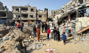 Palestinians inspect the site of an Israeli strike in Rafah in southern Gaza