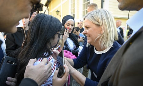 Sweden's prime minister, Magdalena Andersson, signs autographs after giving a speech in Botkyrka, southern Stockholm, on Sunday