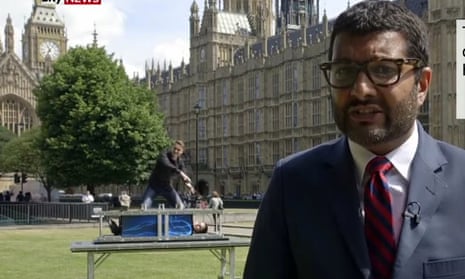 The faked news report shows two magicians rolling their equipment into background of the shot and performing an illusion as Joshi reports on the government’s NHS plans. 