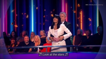 Claudia Winkleman and Dave Arch parodying the kiss cam couple