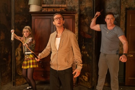 Dan Stevens, centre, with Kathryn Newton and Kevin Durand in Abigail, each brandishing a weapon as they look up at some unseen advancing foe