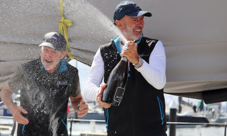 Alive skipper Duncan Hines sprays champagne as he celebrates an overall win in the Sydney to Hobart yacht race.