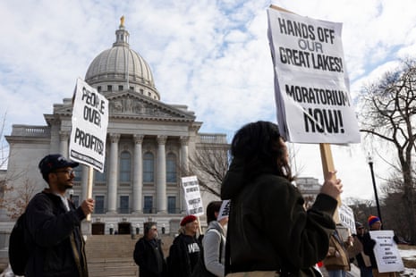 a group of people protesting against datacenters in front of a capitol building