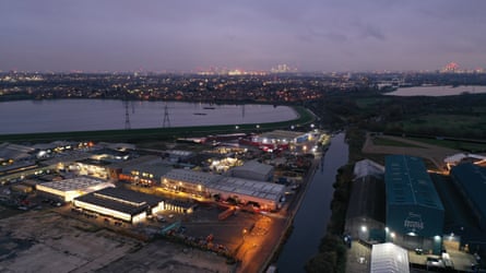 An aerial view of Bloqs at dusk with a large reservoir in the background