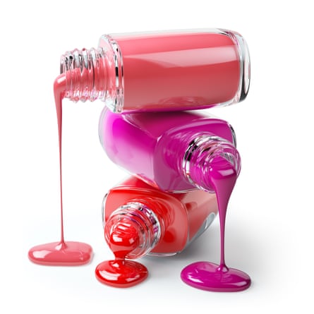 Three open bottles of nail varnish – coral, pink and red – lying on their side and on top of each other, with the varnish inside dripping out of them
