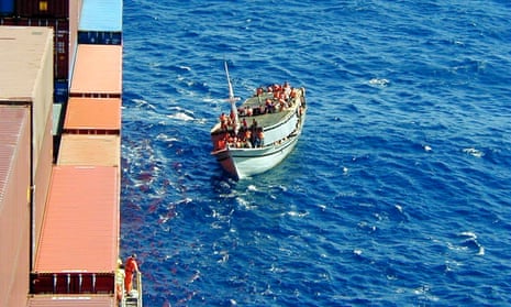 The Tampa pulls up alongside the sinking fishing vessel Palapa before the dramatic rescue of 433 asylum seekers.