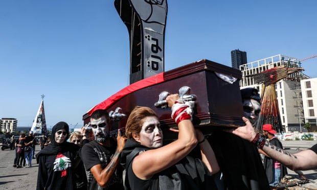 Anti-government protesters stage a symbolic funeral for the country in downtown Beirut