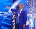 Nigel Farage on stage, gesturing with his arm