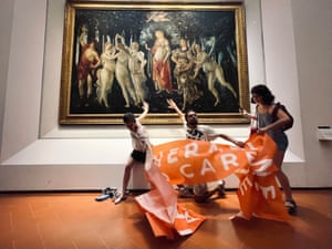 Protestors from the action group Ultima Generazione glue their hands to the glass covering Botticelli’s Primavera at Galleria Degli Uffizi in Florence