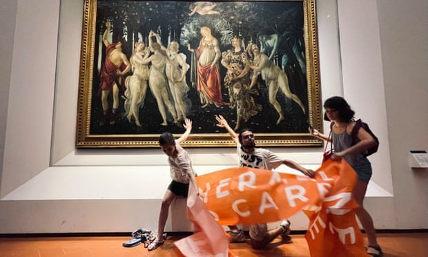 Protestors from the action group Ultima Generazione (Last Generation) with their hands glued to the glass covering Botticelli's Primavera at Galleria Degli Uffizi.