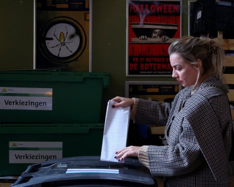 A person casts a vote at the cafe De Boterwaag decorated for Halloween, during the Dutch parliamentary election, in The Hague, Netherlands.