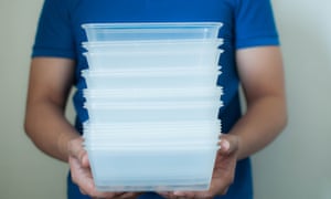 Man holding plastic food containers