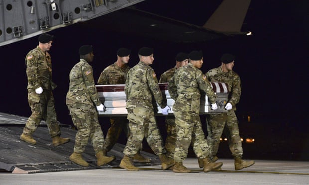 A US army carry team at Dover air force base, Delaware, transfers the remains of Staff Sgt Dustin Wright, who was among four special forces soldiers killed in Niger.