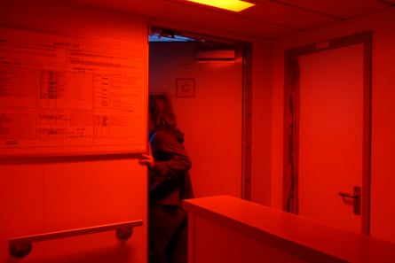 Volunteer deckhand Luca Lamont enters the bridge of the ship during her early morning watch shift from 4am to 8am. At night the lights in the alleyway turn red as it does not impair their night vision as much as normal lights. This makes their job easier as they can quickly shift from red light inside to darkness outside without waiting for their eyes to readjust