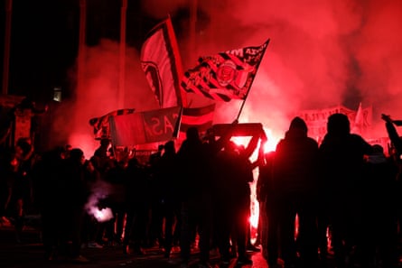 With the attendance capped at 5,000, some Milan fans lit flares and sung songs outside San Siro.