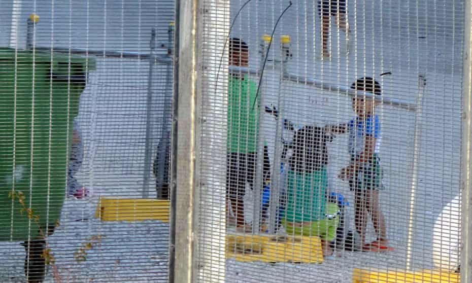 An undated supplied image from Amnesty International showing children playing near a fence at an Australian-run detention centre on the Pacific island nation of Nauru.