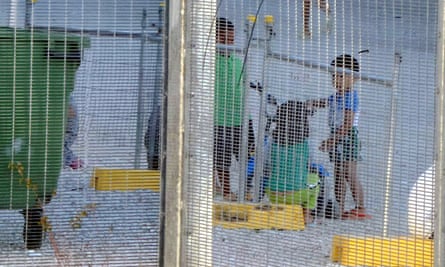 Amnesty International released this undated supplied image showing children playing near a fence at the Australian-run detention centre on Nauru.
