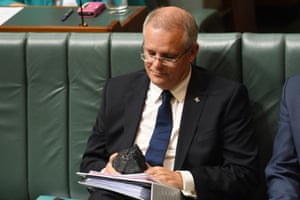 Scott Morrison looks at a piece of coal in Parliament House in Canberra. His government has no policies to deliver on Paris agreement commitments.