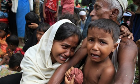 Rohingya refugees crying at a makeshift shelter at the border village of Gumdhum.