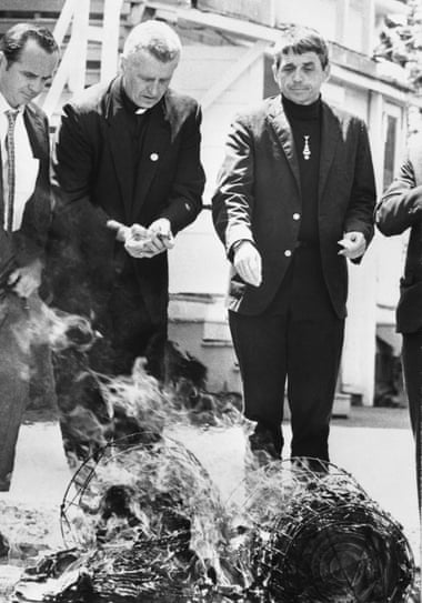 Daniel Berrigan, right, and his brother, Philip Berrigan, burning draft board records in 1968.