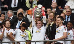 Manchester United’s Wayne Rooney lifts the trophy as they celebrate winning the FA Cup.