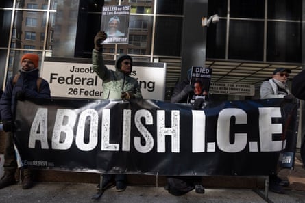 Protesters hold a large sign that says ‘Abolish ICE’