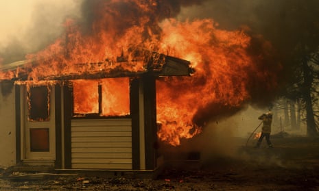 A firefighter battles a fire consuming a home near Bundanoon, New South Wales.