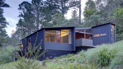The Eco-House in Leura, constructed of blue corrugated iron-like materials, on a hill.
